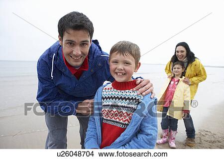 Happy family on beach View Large Photo Image Picture - Happy family on beach. Fotosearch