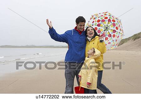 Happy family on beach with umbrella View Large Photo Image Stock Image - Happy family on beach with umbrella. Fotosearch