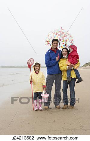 Happy family on beach with umbrella View Large Photo Image Stock Image - Happy family on beach with umbrella. Fotosearch