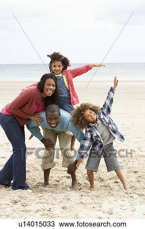 Happy family playing on beach View Large Photo Image Stock Image - Happy family playing on beach. Fotosearch