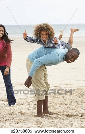 Happy family playing on beach View Large Photo Image Stock Photography - Happy family playing on beach. Fotosearch