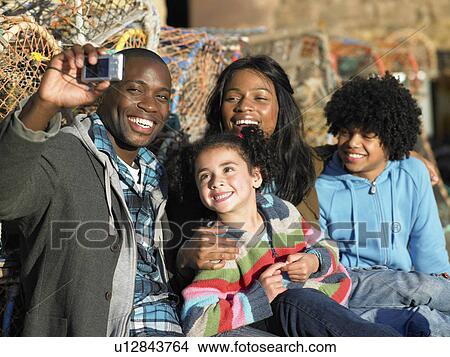 Picture - Happy family taking photo. Fotosearch