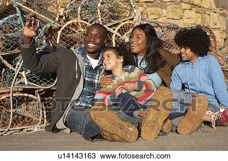 Happy family taking photo View Large Photo Image Stock Image - Happy family taking photo. Fotosearch