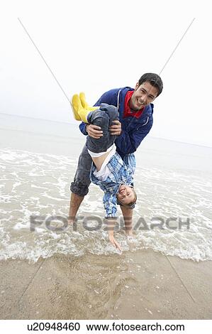 Happy father with son on beach View Large Photo Image Stock Image - Happy father with son on beach. Fotosearch