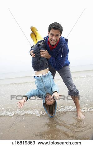 Happy father with son on beach View Large Photo Image Stock Photo - Happy father with son on beach. Fotosearch