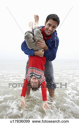 Happy father with son on beach View Large Photo Image Stock Photo - Happy father with son on beach. Fotosearch