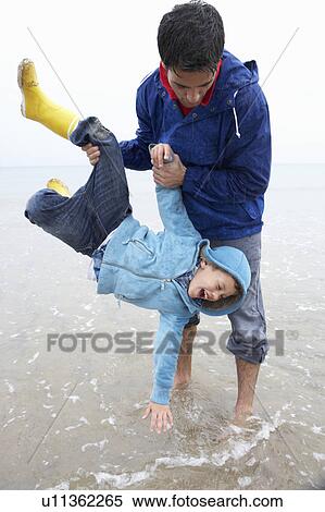 Happy father with son on beach View Large Photo Image Stock Photography - Happy father with son on beach. Fotosearch