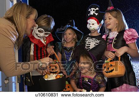 Happy Halloween party with children trick or treating View Large Photo Image Stock Image - Happy Halloween party with children trick or treating. Fotosearch