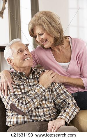 Happy Senior Couple Relaxing At Home View Large Photo Image Stock Image - Happy Senior Couple Relaxing At Home. Fotosearch