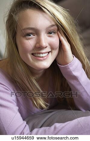 Stock Photo - Happy Teenage Girl Sitting In Bedroom. Fotosearch