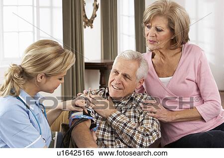 Stock Photography - Health Visitor Taking Senior Man's Blood Pressure. Fotosearch