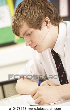 Stock Photo - Male Teenage Student Studying In Classroom. Fotosearch