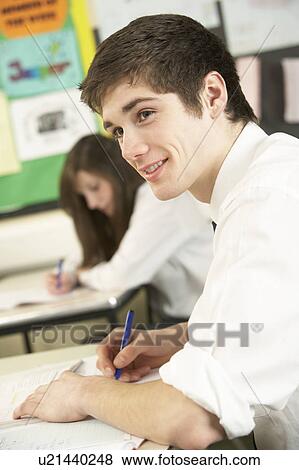 Stock Photo - Male Teenage Student Studying In Classroom. Fotosearch