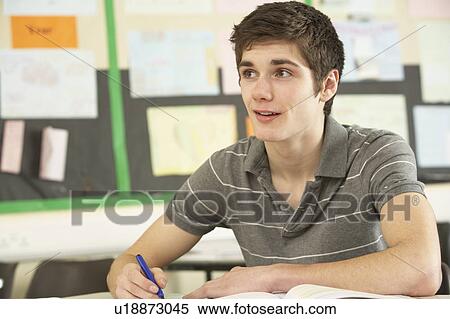 Stock Photography - Male Teenage Student Studying In Classroom. Fotosearch