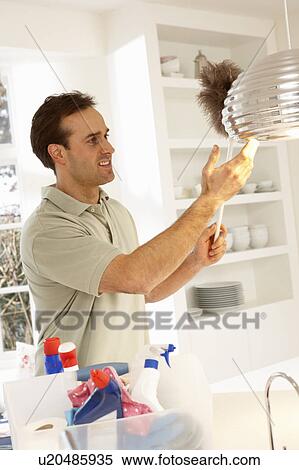Man Cleaning Light Fitting With Feather Duster View Large Photo Image Stock Photography - Man Cleaning Light Fitting With Feather Duster. Fotosearch