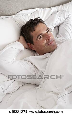 Stock Photo - Man Relaxing In Bed. Fotosearch