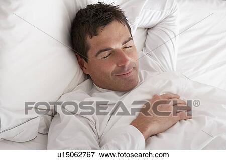 Stock Photo - Man Sleeping Peacefully In Bed. Fotosearch
