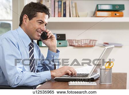 Man Working From Home Using Laptop On Phone View Large Photo Image Stock Photography - Man Working From Home Using Laptop On Phone. Fotosearch