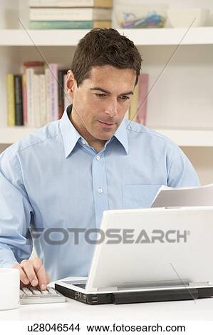 Picture - Man Working From Home Using Laptop. Fotosearch