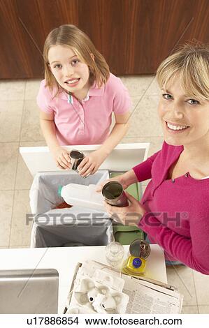 Mother And Daughter Recyling Waste At Home View Large Photo Image Picture - Mother And Daughter Recyling Waste At Home. Fotosearch