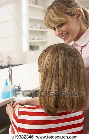 Mother And Daughter Washing Hands At Kitchen Sink View Large Photo Image Stock Photograph - Mother And Daughter Washing Hands At Kitchen Sink. Fotosearch