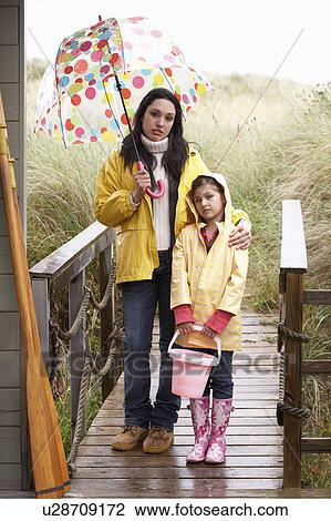 Mother and daughter with umbrella View Large Photo Image Stock Image - Mother and daughter with umbrella. Fotosearch