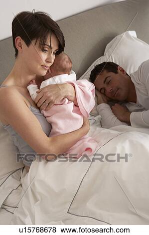 Mother Cuddling Newborn Baby In Bed At Home View Large Photo Image Stock Photo - Mother Cuddling Newborn Baby In Bed At Home. Fotosearch