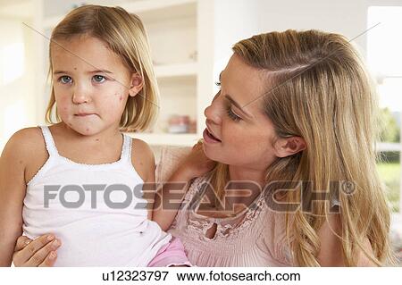 Mother nursing sick child View Large Photo Image Stock Photo - Mother nursing sick child. Fotosearch