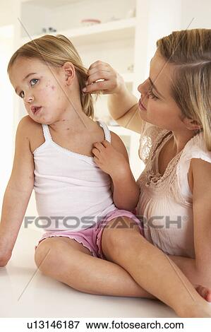 Stock Photo - Mother nursing sick child. Fotosearch