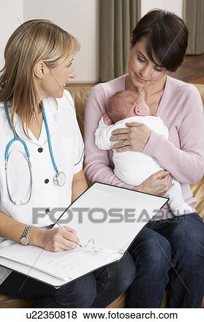 Stock Photo - Mother With Newborn Baby Talking With Health Visitor At Home. Fotosearch