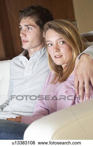 Nervous Looking Teenage Girl Sitting On Sofa At Home With Boyfri View Large Photo Image Stock Photo - Nervous Looking Teenage Girl Sitting On Sofa At Home With Boyfri. Fotosearch