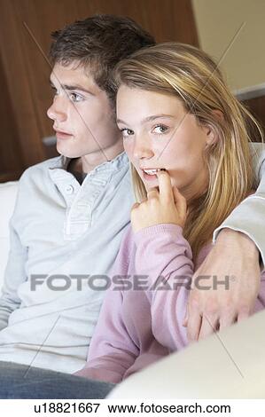 Nervous Looking Teenage Girl Sitting On Sofa At Home With Boyfri View Large Photo Image Stock Photo - Nervous Looking Teenage Girl Sitting On Sofa At Home With Boyfri. Fotosearch