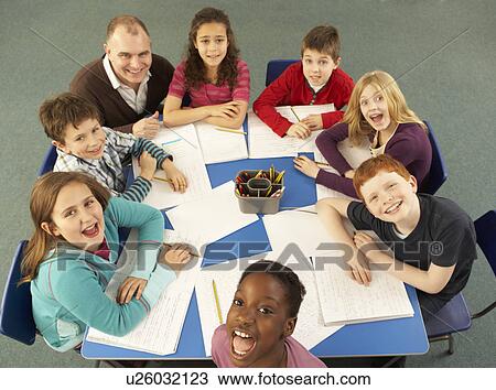 Overhead View Of Schoolchildren Working Together At Desk With Teacher View Large Photo Image Stock Image - Overhead View Of Schoolchildren Working Together At Desk With Teacher. Fotosearch