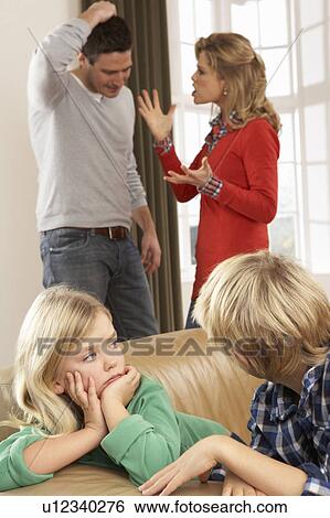 Stock Photograph - Parents Having Argument At Home In Front Of Children. Fotosearch