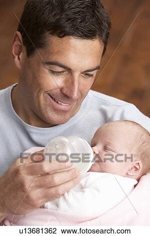 Portrait Of Father Feeding Newborn Baby At Home View Large Photo Image Stock Image - Portrait Of Father Feeding Newborn Baby At Home. Fotosearch