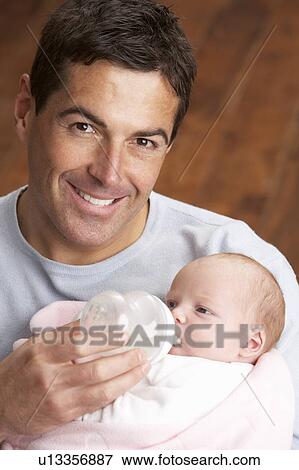 Portrait Of Father Feeding Newborn Baby At Home View Large Photo Image Stock Photo - Portrait Of Father Feeding Newborn Baby At Home. Fotosearch