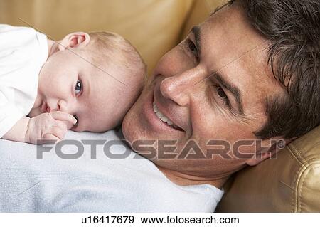 Portrait Of Father With Newborn Baby At Home View Large Photo Image Stock Photo - Portrait Of Father With Newborn Baby At Home. Fotosearch