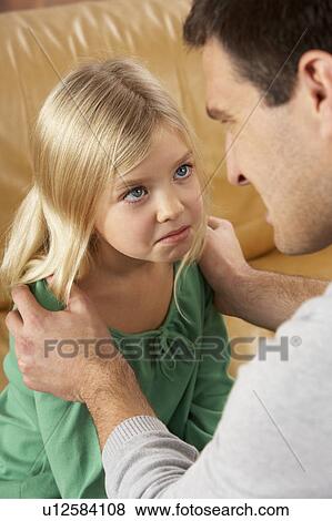 Stock Photo - Portrait Of Frightened Daughter Looking At Father. Fotosearch