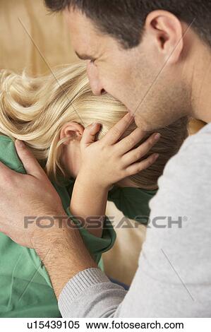 Stock Photography - Portrait Of Frightened Daughter Looking At Father. Fotosearch