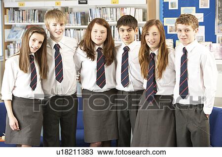Stock Image - Portrait Of Group Of Teenage Students In Library. Fotosearch
