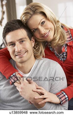Portrait Of Happy Young Couple At Home View Large Photo Image Stock Photo - Portrait Of Happy Young Couple At Home. Fotosearch