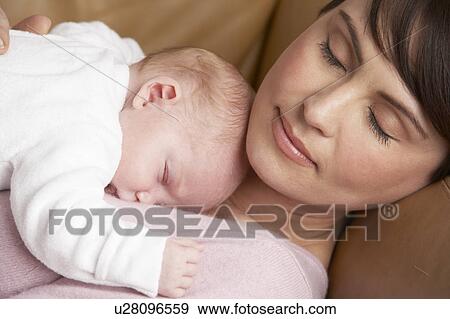 Portrait Of Mother Resting With Newborn Baby At Home View Large Photo Image Stock Photo - Portrait Of Mother Resting With Newborn Baby At Home. Fotosearch