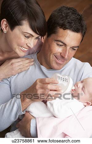 Portrait Of Parents Feeding Newborn Baby At Home View Large Photo Image Stock Image - Portrait Of Parents Feeding Newborn Baby At Home. Fotosearch