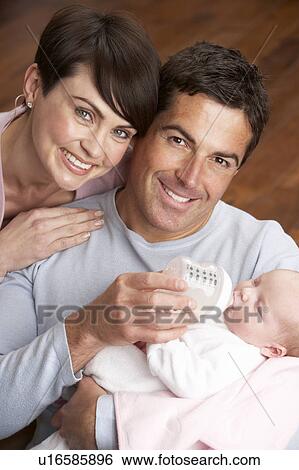 Portrait Of Parents Feeding Newborn Baby At Home View Large Photo Image Stock Photograph - Portrait Of Parents Feeding Newborn Baby At Home. Fotosearch