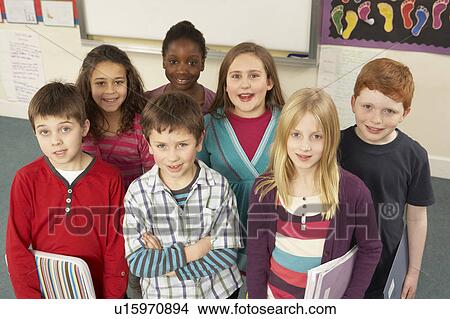 Picture - Portrait Of Schoolchildren Standing In Classroom. Fotosearch