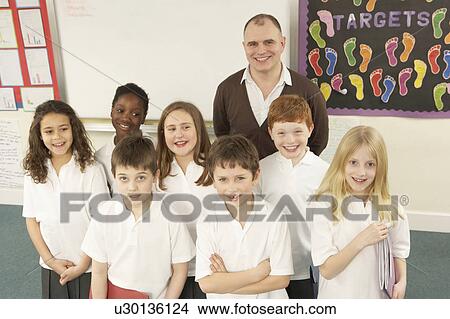 Picture - Portrait Of Schoolchildren Standing In Classroom. Fotosearch