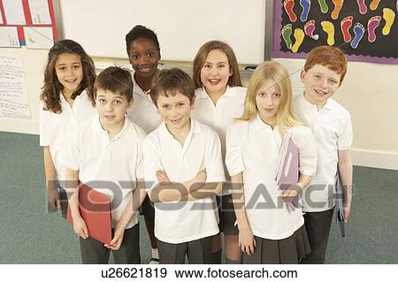 Stock Photo - Portrait Of Schoolchildren Standing In Classroom. Fotosearch
