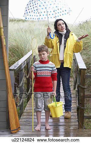 Picture - Sad woman and child with umbrella. Fotosearch