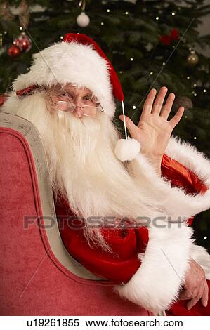 Santa Claus Sitting In Armchair In Front Of Christmas Tree View Large Photo Image Stock Photography - Santa Claus Sitting In Armchair In Front Of Christmas Tree. Fotosearch