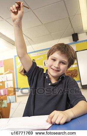 Stock Photo - Schoolboy Answering Question In Classroom. Fotosearch